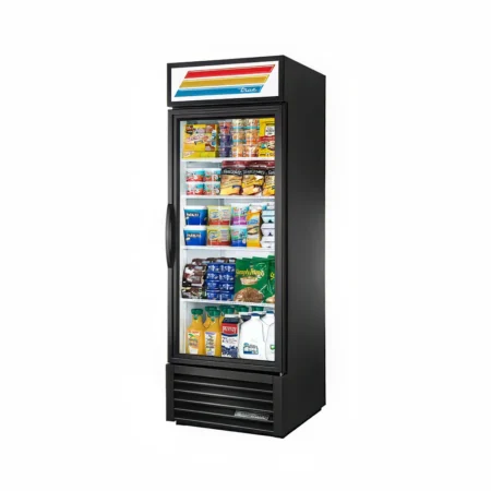 A single-door True brand commercial glass door merchandiser refrigerator in black, stocked with various chilled beverages, dairy products, and snacks against a white background.