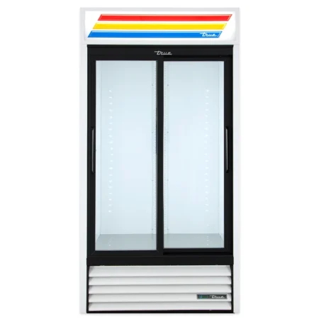 Front view of an empty white True GDM-33 commercial refrigerator with two black-framed sliding glass doors, internal LED lighting, and a signature red, yellow, and blue striped lighted sign at the top.