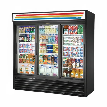 A Three-quarter perspective view from the left side of a large, black True GDM-69-HC commercial refrigerator featuring three sliding glass doors, fully stocked with dairy products, juices, and beverages, with an illuminated striped top sign. Would you like the technical specifications or shelving layout