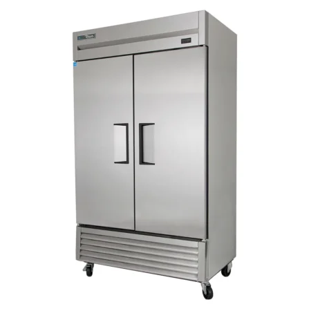 A high-angle front view of a True Manufacturing T-43-HC stainless steel reach-in refrigerator featuring two solid swing doors with recessed handles, a digital temperature display on the top right, a bottom-mounted compressor with a vented grill, and heavy-duty swivel casters.