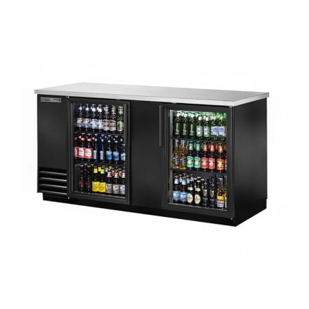 A front perspective view of a black True commercial back bar refrigerator with two glass doors, fully stocked with various beer bottles and canned beverages, and a stainless steel countertop.