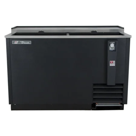 A straight-on front view of a black commercial bottle cooler featuring sliding top lids, a stainless steel rim, and a centered bottle opener.