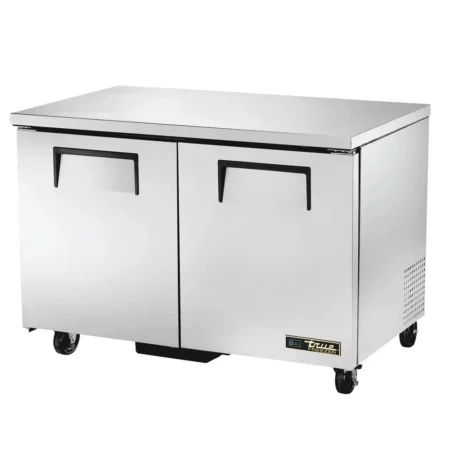 A stainless steel True Manufacturing TUC-48 undercounter freezer featuring two solid doors with recessed handles and swivel casters.
