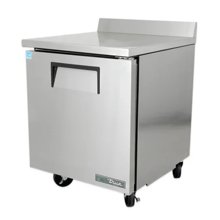 A stainless steel True Manufacturing one-door worktop freezer featuring a flat work surface with a built-in rear backsplash, recessed handle, and heavy-duty swivel casters.