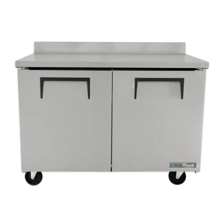 A front-facing view of a True TWT-48 stainless steel worktop refrigerator with two solid doors, recessed horizontal handles, a full-width integrated backsplash, and heavy-duty casters.