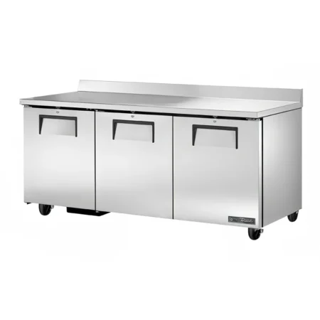 A large, three-door True stainless steel worktop refrigerator featuring a 72-inch wide work surface, integrated rear backsplash, recessed handles, and heavy-duty locking casters.