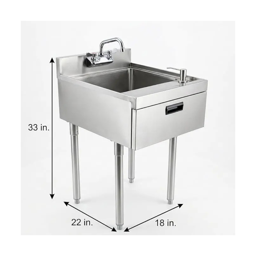 Stainless Steel Underbar Hand Sink With Soap And Towel Dispensers Bowl Faucet And Drain Basket 5 A Two-Quarter Perspective Of A High-End Stainless Steel Underbar Workstation In A Modern, Dimly Lit Lounge. The Configuration Includes A Single-Compartment Hand Sink With A Deck-Mounted Gooseneck Faucet And Integrated Soap Dispenser, An Adjacent Insulated Ice Bin With A Sliding Cover, And A Tiered Speed Rail For Spirit Bottles. The Setup Is Integrated With A Back Bar Glass-Door Refrigerator And Open Shelving For Glassware, Situated In A Professional Bar Environment With Warm Ambient Lighting.