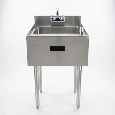 A two-quarter perspective and a front-facing view of a professional stainless steel hand sink on a white background. The unit features a single deep bowl, a backsplash with a deck-mounted gooseneck faucet, and a built-in pump soap dispenser. The sink is supported by four stainless steel legs and includes a front apron with a black recessed handle for a clean, industrial look.
