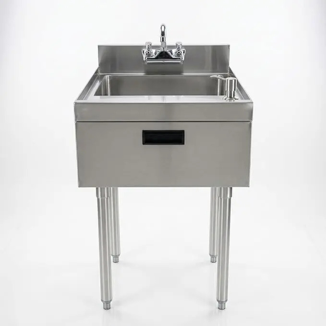 Stainless Steel Underbar Hand Sink With Soap And Towel Dispensers Bowl Faucet And Drain Basket 2 A Two-Quarter Perspective And A Front-Facing View Of A Professional Stainless Steel Hand Sink On A White Background. The Unit Features A Single Deep Bowl, A Backsplash With A Deck-Mounted Gooseneck Faucet, And A Built-In Pump Soap Dispenser. The Sink Is Supported By Four Stainless Steel Legs And Includes A Front Apron With A Black Recessed Handle For A Clean, Industrial Look.
