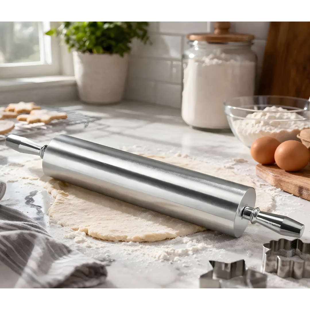 18&Quot; Aluminum Rolling Pin Extra Heavy Duty Commercial Bakery Dough Roller Pizza 5 A Commercial-Grade Aluminum Rolling Pin Resting On A Floured Marble Countertop On Top Of Flattened Dough. The Image Is Captured In A Two-Quarter Perspective In A Bright Kitchen Setting With Eggs, A Mixing Bowl, And Star-Shaped Cookie Cutters In The Background.
