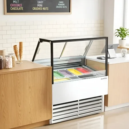 Marchia GIC-7-ST 42" 7-Pan Flat Glass Cabinet Display Freezer filled with colorful artisan gelato on a cafe counter